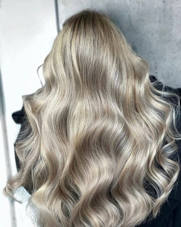 Soft ash blonde waves after a brown to blonde colour change at Gusto Hair, London