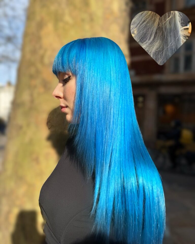 Vivid electric blue hair with a full fringe, coloured at Gusto Hair, London