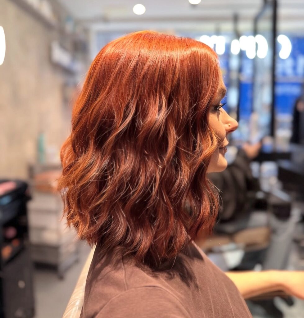 Rich red copper bob with soft waves at Gusto Hair London