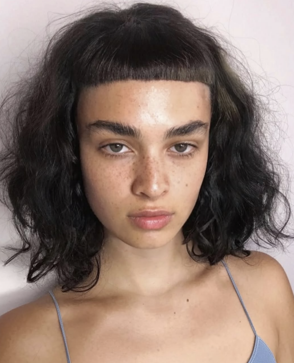 Short dark bob with a blunt micro fringe at Gusto Hair, London