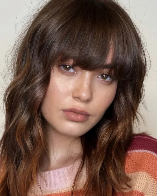 Brunette waves with a full curtain fringe at Gusto Hair London