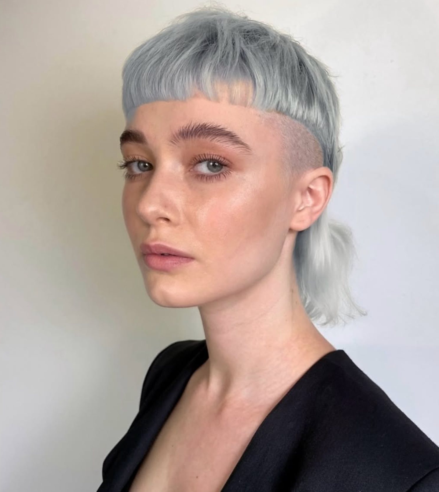 Icy silver-blue mullet with a micro fringe and shaved side at Gusto Hair London