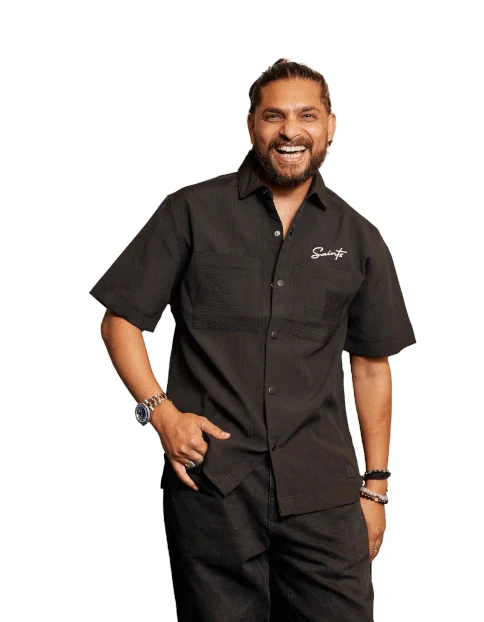 Assi, smiling, in a black shirt
