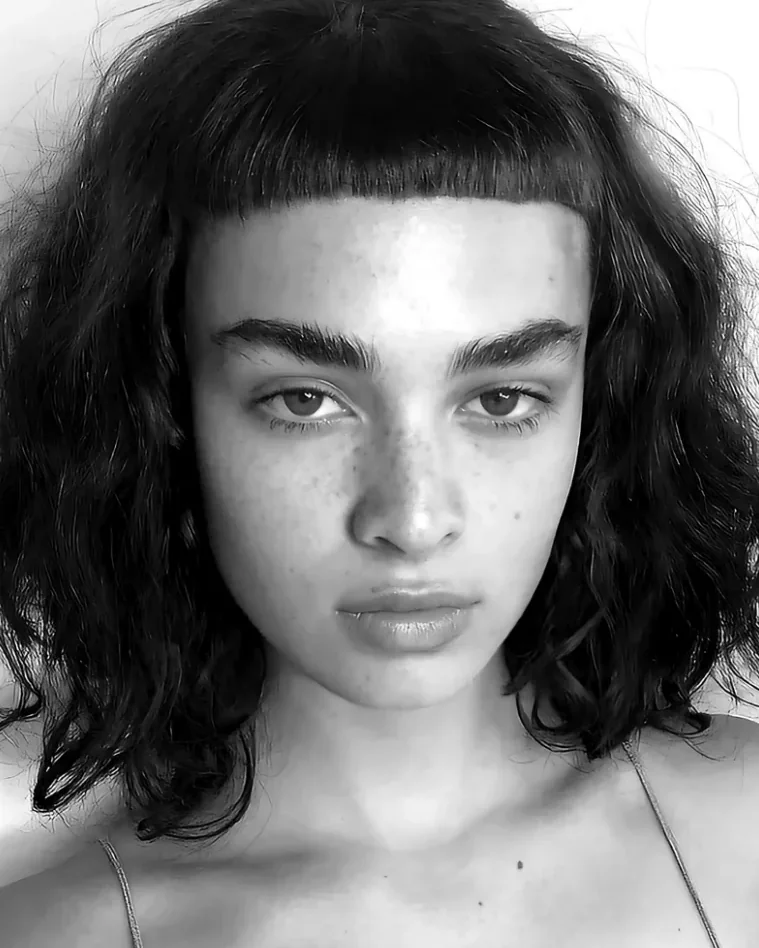 Black and white portrait of a curly bob with a blunt micro fringe, Gusto Hair London