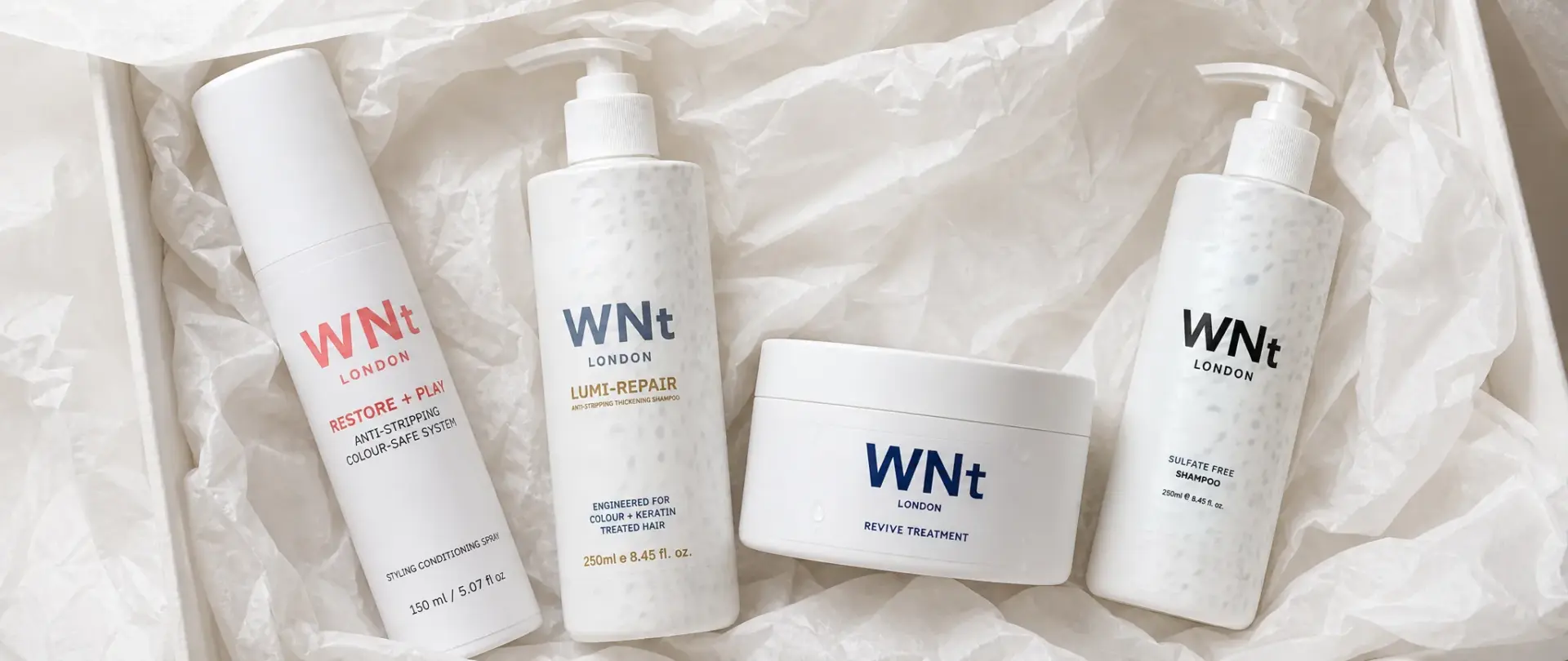 The WNt London range in a gift box: Restore + Play spray, Lumi-Repair shampoo, Revive Treatment mask and sulphate-free shampoo